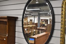 An early 20th Century oval wall mirror