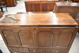 A period oak four panel kist having three drawers to base, with later loose top