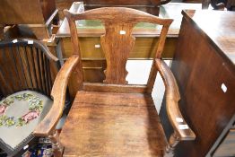 A period oak carver chair having vase back and solid seat