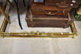A vintage brass effect fire guard