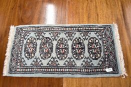 A traditional prayer style rug , approx. 62 x 32cm
