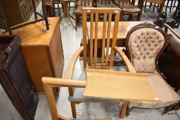 A Peter Hall and son of Staveley bespoke golden oak arm chair or carver with a retractable reading