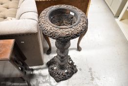 A Victorian torchere/plant stand in a Black Forest style with heavily carved flora and fauna imagery