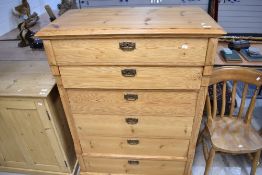 A stripped pine tall boy chest of six drawers