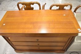 A modern chest of three drawers and one secret drawer marked Mobilier Fabrique France
