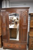 A Victorian wardrobe with mahogany case and under drawer