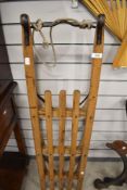 An early 20th century wooden framed childs sledge