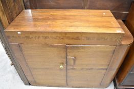 An Art Deco sapele cocktail cabinet or breakfast bar with internal shelves and drawers