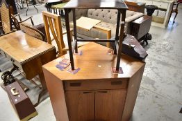 A teak G plan corner unit having drop flap drawer and concave cupboard base