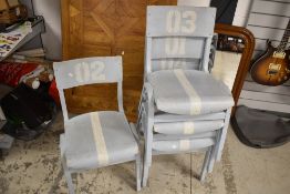 A set of four vintage childrens utility chairs having shabby chiq paint work
