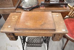 An oak cased treadle sewing machine