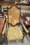 A traditional stained frame armchair having bergere back