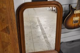 A modern mantel or hall way mirror with a sapele wood frame