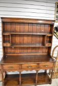 A good quality reproduction Welsh dresser base and plate rack in oak