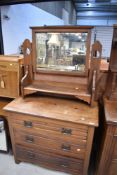 A chest of three drawers with a dressing table mirror top