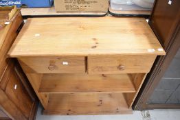 A modern pine small bookshelf with drawers over