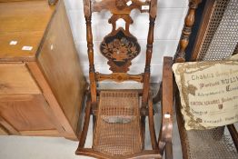 A 19th Century folding campaign style chair having canework seat and inlaid decoration throughout