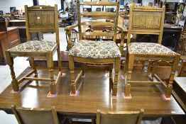 An Old Charm oak dining table and set of four dining chairs plus one carver