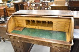 An early 20th Century oak roll top desk, width approx. 137cm