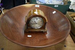 A large turned fruit bowl and an Edwardian mantel clock.