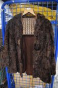 A vintage ladies Violet Tucker Astrakhan short length jacket with a crocodile skin handbag