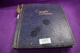 A cigarette picture album containing a selection of different genres of Player's cigarette cards.