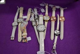 Ten girls/ladies fashion watches, all having white straps.