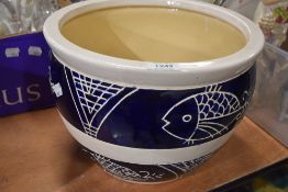 A glazed planter having fish design (af).