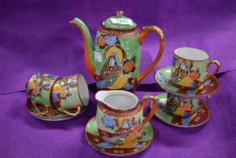A Japanese part tea service having elaborate decoration of Geisha on green ground