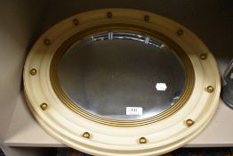 A 1950's nautical themed bulls eye or port hole mirror with convex glass and cream and gilt frame.