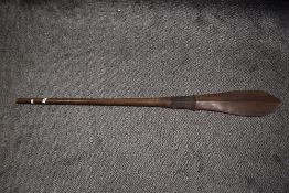 A Polynesian Oceanic art possibly Iron wood paddle having carved grip and tapered form, slight