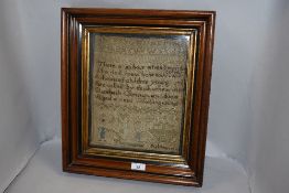 An early Victorian needle work sampler reading ' There is an hour when I must die come nor do I know