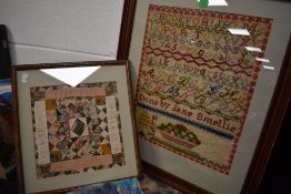 A 19th century hand-stitched coverlet fragment, within a modern mount and frame, under glass, sold