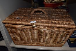 A woven wicker picnic hamper, vacant interior