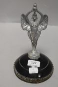 A vintage plated metal 'Victory' car mascot, mounted to a substantial domed base
