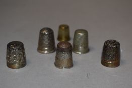 Two silver thimbles and three others
