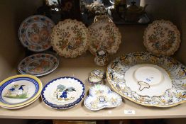A selection of Continental tin glazed earthernware, including Rouen and Quimper,