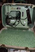 A vintage mid century Cresta sewing machine, in green with peddle, power cable and original case