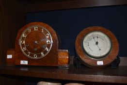 An Edwardian mantel clock having birds eye maple and mahogany case along with a button form oak