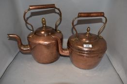Two antique copper kettles, each cover with brass acorn finial