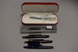 A cased Sheaffer ball point pen, a Parker ballpoint pen and three Parker fountain pens