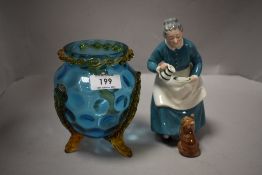 A Royal Doulton 'The Favorite' figurine HN2249, sold along with a blue and amber glass vase of