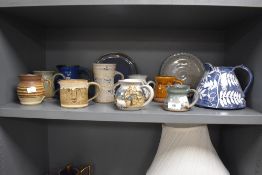A good selection of mid century styled studio pottery jugs, cups and mugs