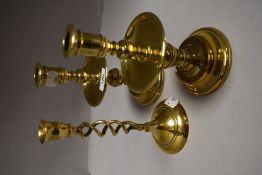 A pair of good quality brass candlesticks, each with central drip tray, sold with a single brass