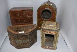 A group of four novelty biscuit tins, formed as a mantel clock, chest of drawers, tin with