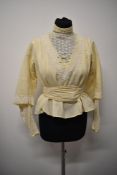 An Edwardian bodice in cream having tulle lace to bodice and lower portions of sleeves with separate