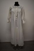 A Victorian/ Edwardian nightdress having intricate cutwork, pin tucks to bodice and ladder work,
