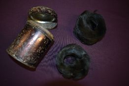 An unusual lot, consisting of an antique tin containing a pair of black fur childrens cuffs or