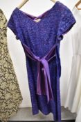 Two vintage dresses to include late 1950s purple lace Ridella dress and metallic 1960s.
