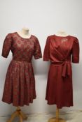 Two vintage 1950s red dresses, including red, gold and brown brocade dress, both having side metal